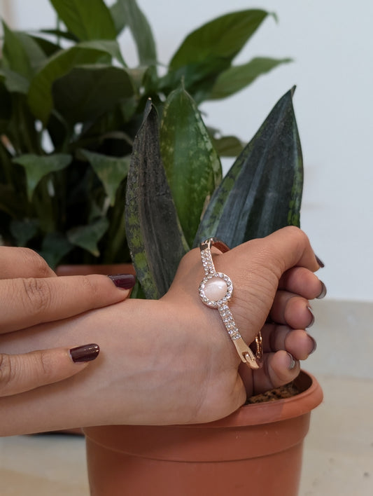 A Pink stud in the golden Bracelet