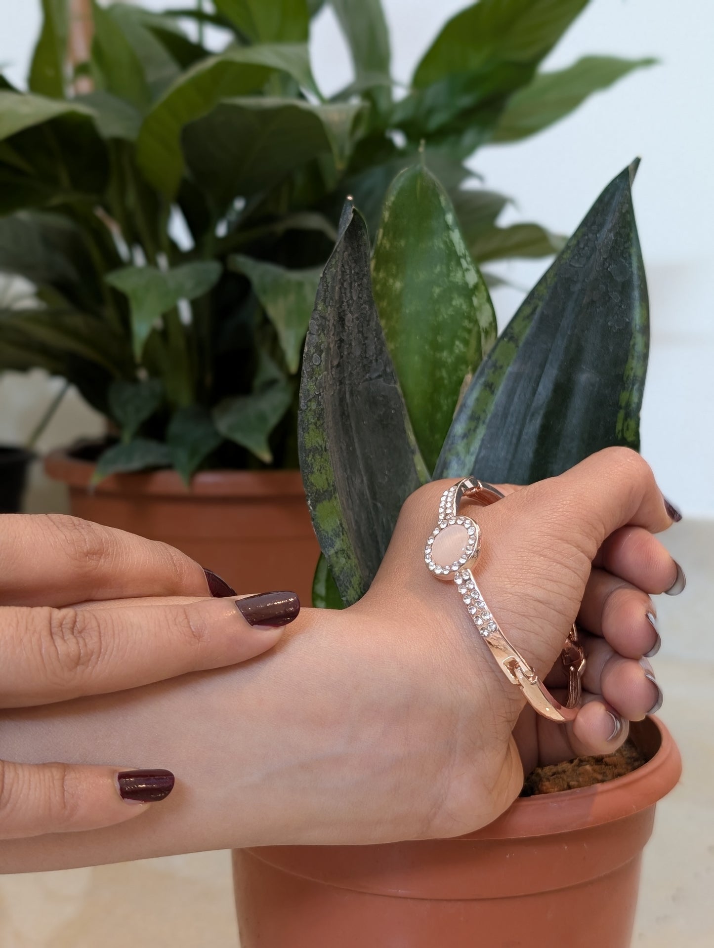 A Pink stud in the golden Bracelet