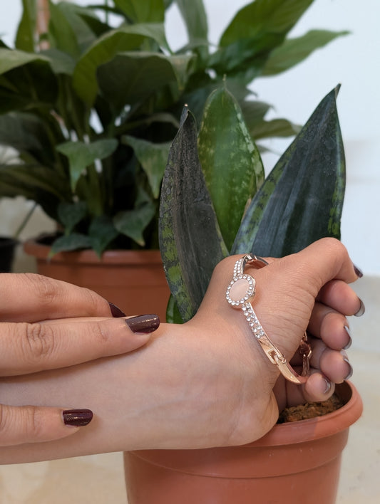 A Pink stud in the golden Bracelet