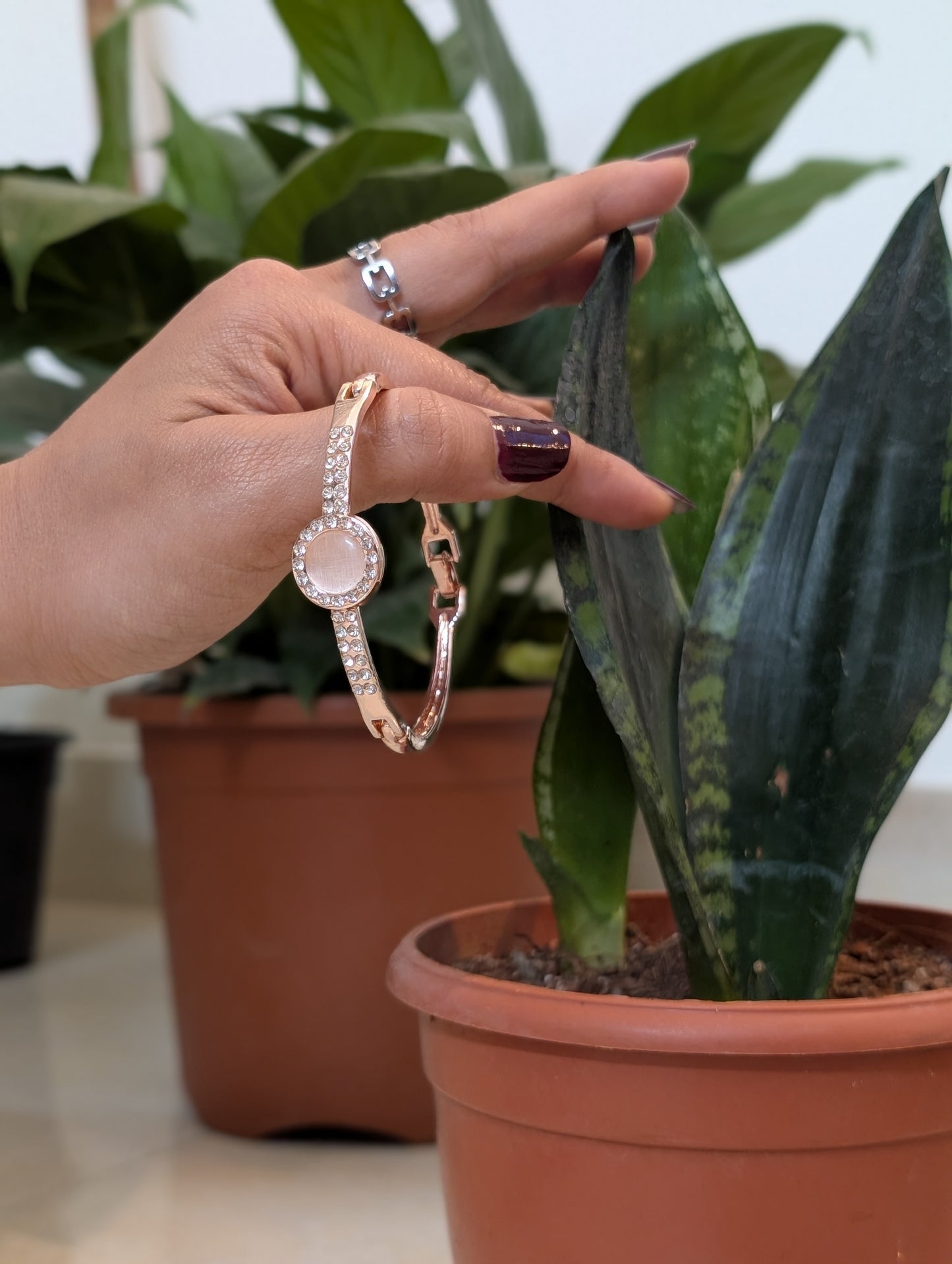 A Pink stud in the golden Bracelet